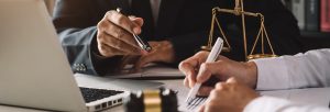 business people and lawyers discussing contract papers sitting a